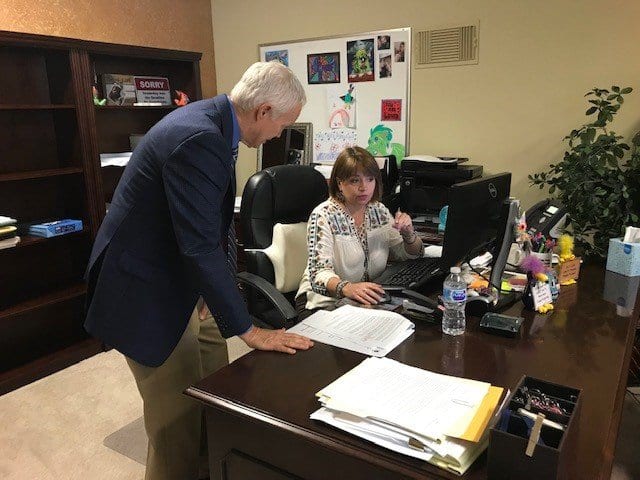 Jerry Llewellyn reviewing hiring and staffing plans with an office manager