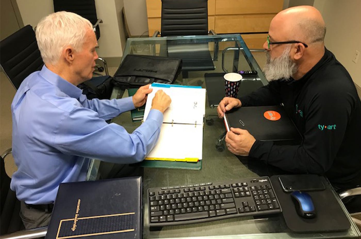 Jerry Llewellyn reviewing a leadership development plan with a business owner