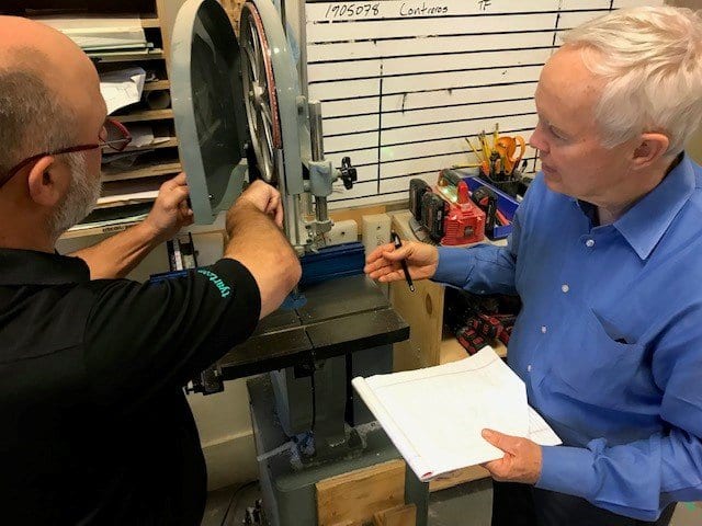 Jerry Llewellyn on a shop floor walking through equipment and production costs with an operator